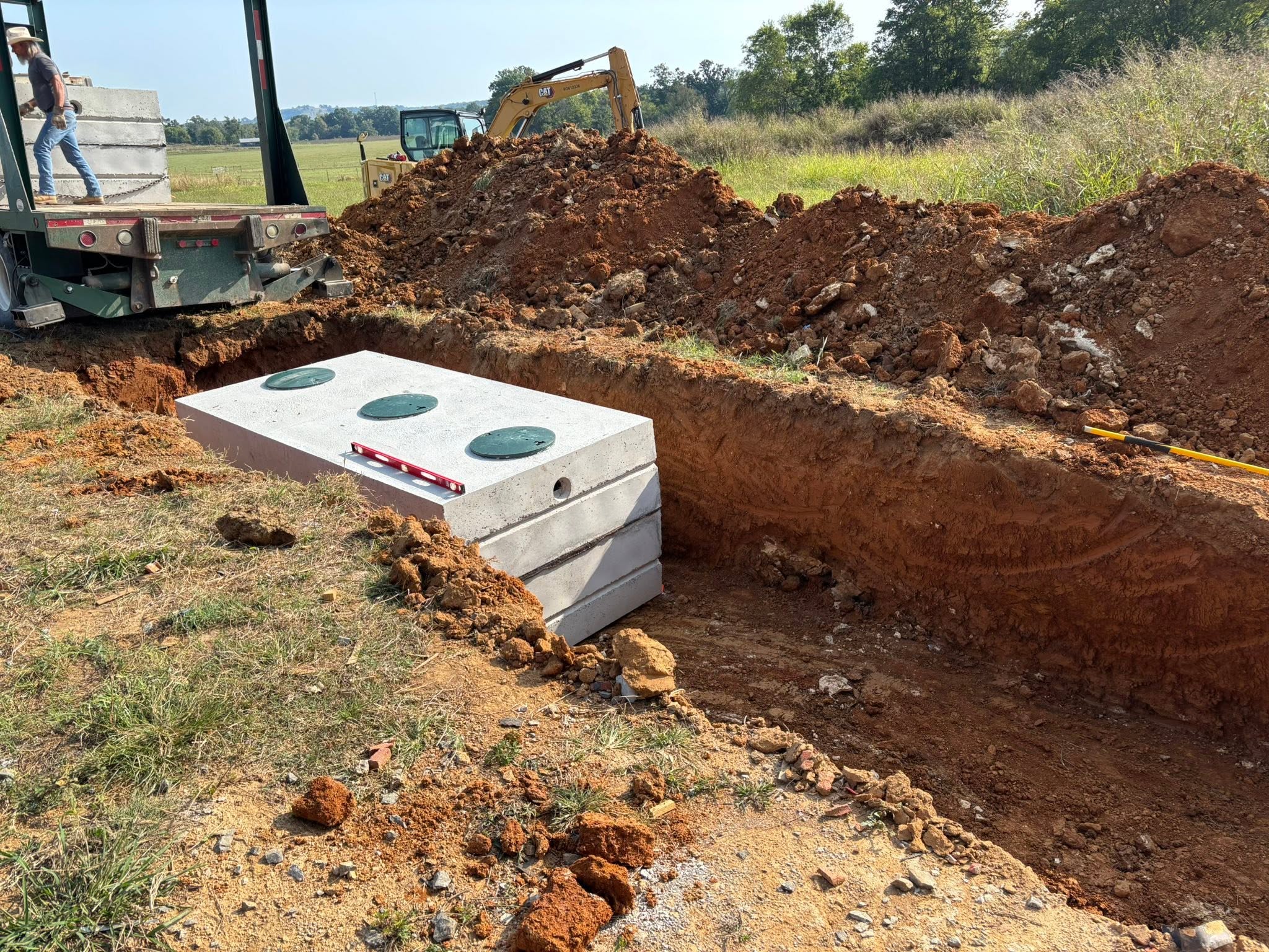 Concrete septic tank installation and excavating on a Wilson County job site